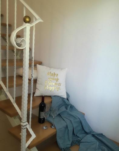 a table with a pillow and a wine glass at Apartment Luce in Pićan