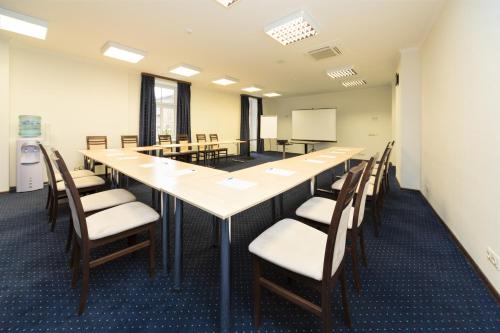 a large conference room with a long table and chairs at Rixwell Gertrude Hotel in Riga
