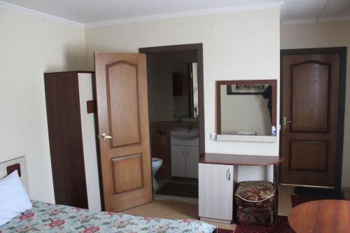 a bedroom with a bed and a dresser at Piramid in Krasnodar