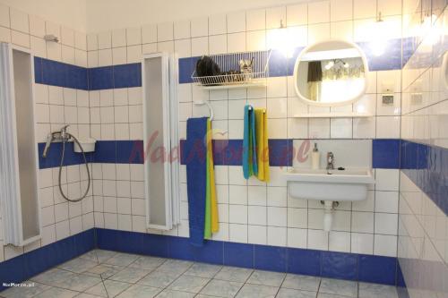 a bathroom with a sink and a mirror at Bursztynek in Gdynia