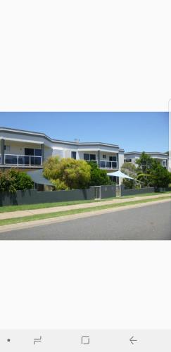 two photographs of a building on the side of a street at Blue horizon in Yeppoon