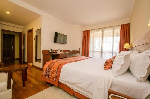Ένα ή περισσότερα κρεβάτια σε δωμάτιο στο Waridi Paradise Hotel and Suites