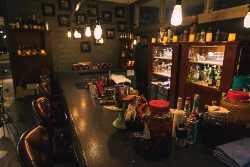 a bar with bottles of alcohol on a counter at Mizno Hotel in Fujikawaguchiko