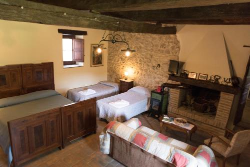 a living room with a bed and a fireplace at Agriturismo Santa Giusta in Poggio San Lorenzo