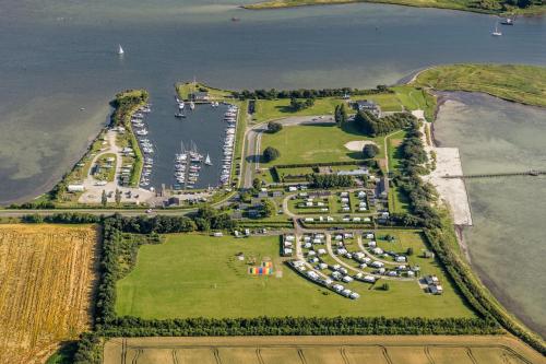 an aerial view of an island with a marina at Nakskov Fjord Camping & Cottages in Nakskov