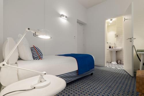 a bedroom with a bed and a bathroom with a sink at Hotel 34B - Astotel in Paris