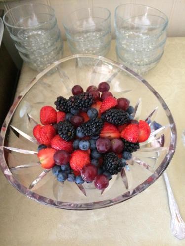 a glass bowl filled with berries on a table at Acorn Guest House in Hull in Hull