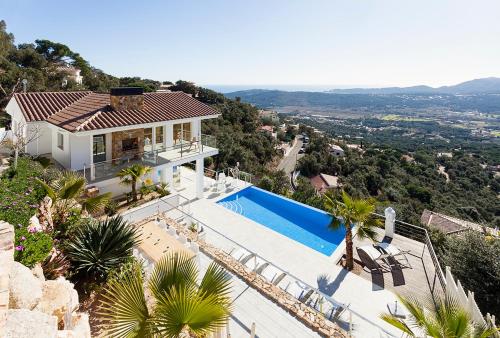 a villa with a swimming pool and a house at Villa Pacifica in Santa Cristina d'Aro