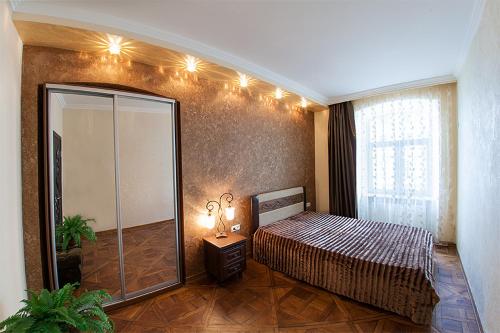 a bedroom with a bed and a glass shower at Rynok Square - the heart of Lviv in Lviv