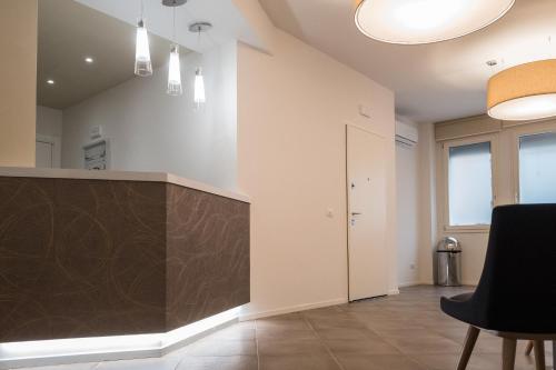 a large kitchen with a counter in a room at Letto A Castello in Ferrara