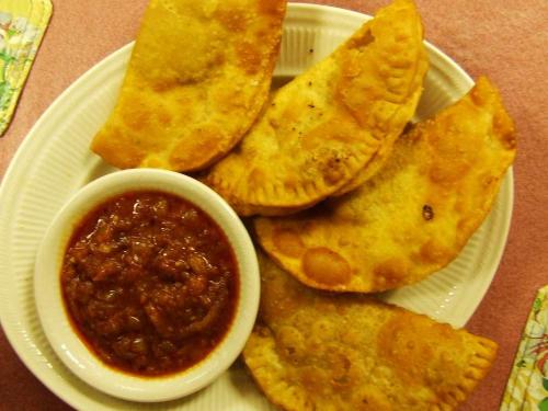 a plate of food with tacos and a bowl of salsa at Keur Chérie in Sali Nianiaral