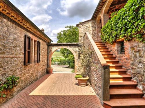 an entrance to a brick building with a stairway at L'Aiolina in Vagliagli