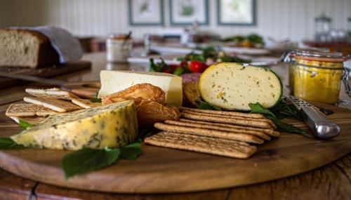 a plate of cheese and crackers on a table at Three Tree Hill Lodge in Bergville