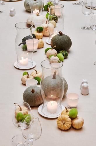 a table with wine glasses and candles and pumpkins at Hotel Royal Astrid in Aalst