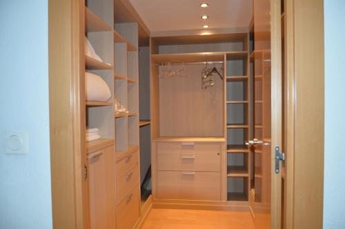 a walk in closet with white cabinets and a glass door at En el Centro de Pamplona, La Taconera in Pamplona