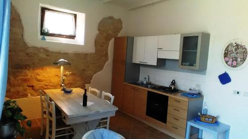 a small kitchen with a wooden table and a sink at Agriturismo Carincone in Pergola