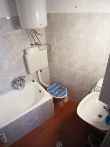 a bathroom with a tub and a toilet and a sink at Apartment old town in Primošten