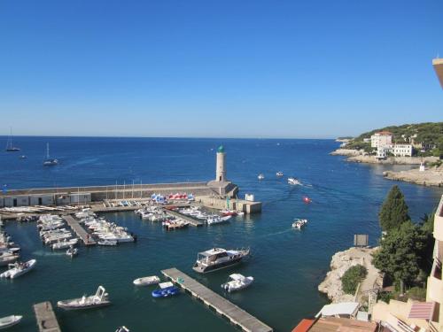 a group of boats docked in a harbor with a lighthouse at BY Cassis chambre privée dans maison familiale in Cassis