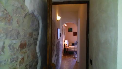 a hallway leading to a room with a stone wall at Agriturismo Carincone in Pergola