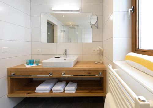 a bathroom with a sink and a mirror at Family Apart Stubai in Fulpmes