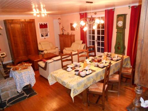 a dining room with a table and a living room at Chambres d'hôtes Al Camp d'Espalougues in Ur