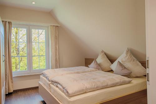 a bedroom with a bed and a large window at Schrebenza in Burg Kauper