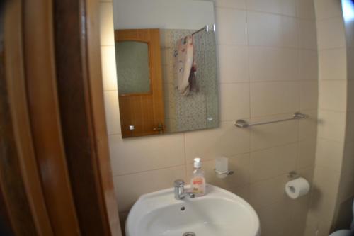 a bathroom with a sink and a mirror at Casa Omer in Eforie Nord