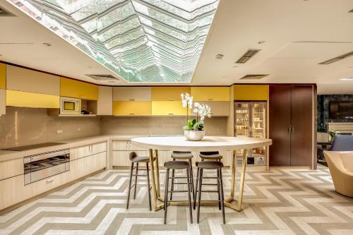a kitchen with a table and chairs and a skylight at Mercure Paris Arc de Triomphe Etoile in Paris