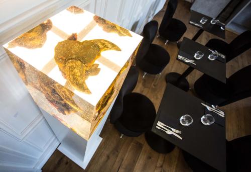 a table with a sculpture on it next to chairs at L'Esplanade Lille in Lille