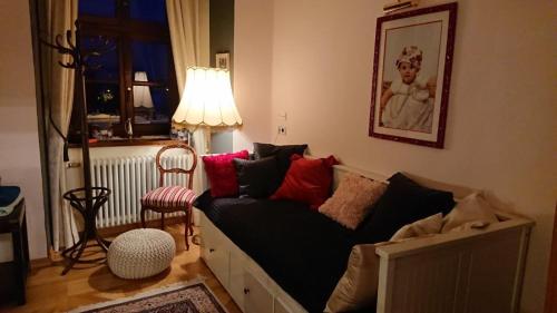 a living room with a couch and a lamp at Schloss Gmünd in Gmünd