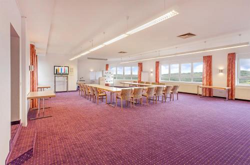 a large room with a table and chairs at Ringhotel Roggenland in Waldeck