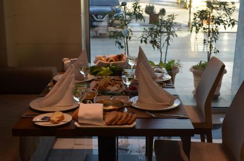 a table with plates of food and napkins on it at B Business Hotel & Spa in Antalya