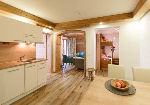 a kitchen with a table with a bowl of fruit on it at Family Apart Stubai in Fulpmes