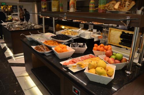 a buffet line with different types of fruits and vegetables at B Business Hotel & Spa in Antalya