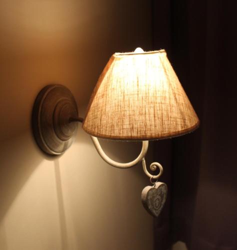a lamp with a heart on the side of it at B&B Villa Verde in De Haan