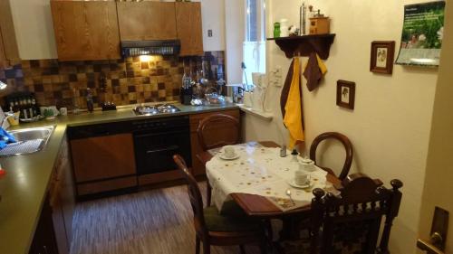 a kitchen with a table and a small kitchen with a stove at ABT Private Rooms - Bed and Breakfast - Hannover (room agency) in Hannover