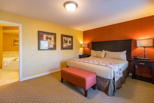 a bedroom with a bed and a red stool at Vacation Village in the Berkshires in Hancock