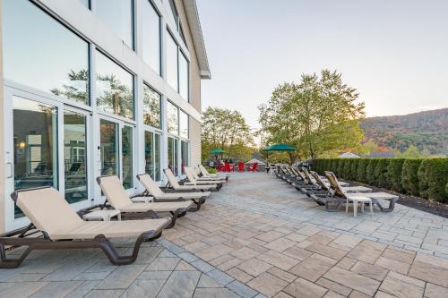 a row of lounge chairs sitting outside of a building at Vacation Village in the Berkshires in Hancock
