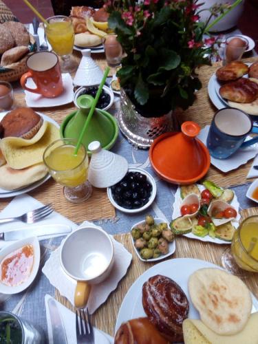 a table topped with plates of food and drinks at Riad Jakoura in Marrakech