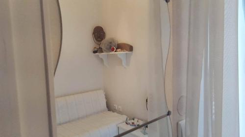 a small bathroom with a shower and a mirror at Irini's home in Volos