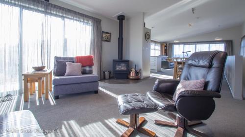 a living room with two chairs and a couch at Hillcrest Lodge B - Lake Tekapo in Lake Tekapo