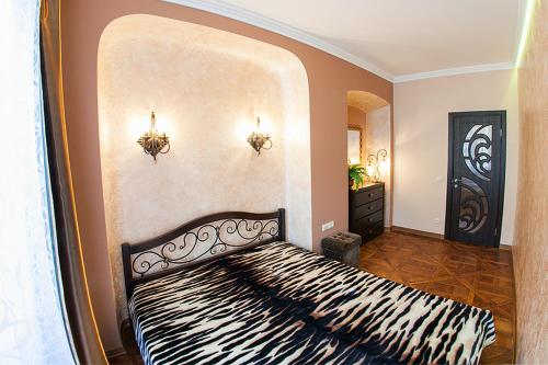 a bedroom with a zebra print bed in a room at Rynok Square - the heart of Lviv in Lviv