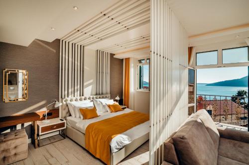 a bedroom with a large bed and a balcony at Apartments Master 5 in Herceg-Novi