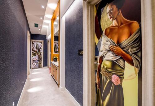 a hallway with a painting of a woman on the wall at Apartments Master 5 in Herceg-Novi