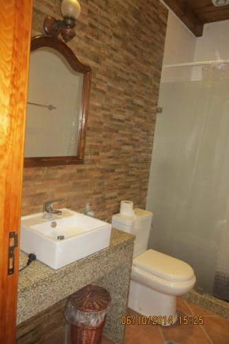 un bagno con lavandino, WC e specchio di Casa da Avó, campo praia a 2 kms do mar a Espinho