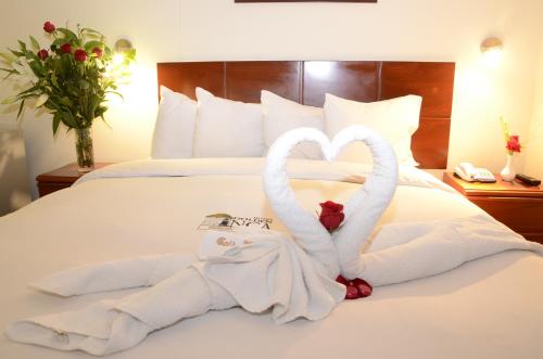 two swans made out of towels on a bed at Golden Inca Hotel in Cusco