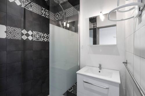 a bathroom with a white toilet and a sink at Cosy Solidor Beach View in Saint Malo