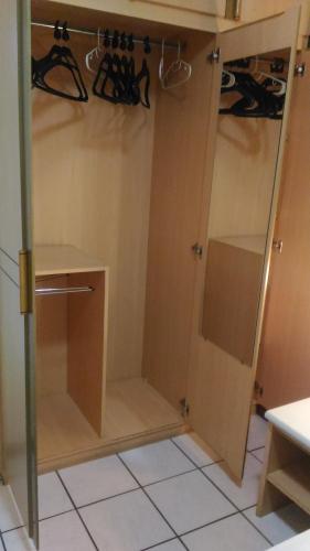 a kitchen with a cupboard with hangers and shoes at Apart Hotel Quartier Latin in Vitória