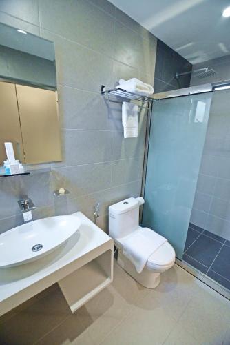 a bathroom with a sink and a toilet and a shower at Diamond Inn in Kota Kinabalu