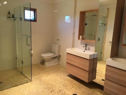 a bathroom with a shower, sink, and toilet at Swan Valley Sisters in Henley Brook